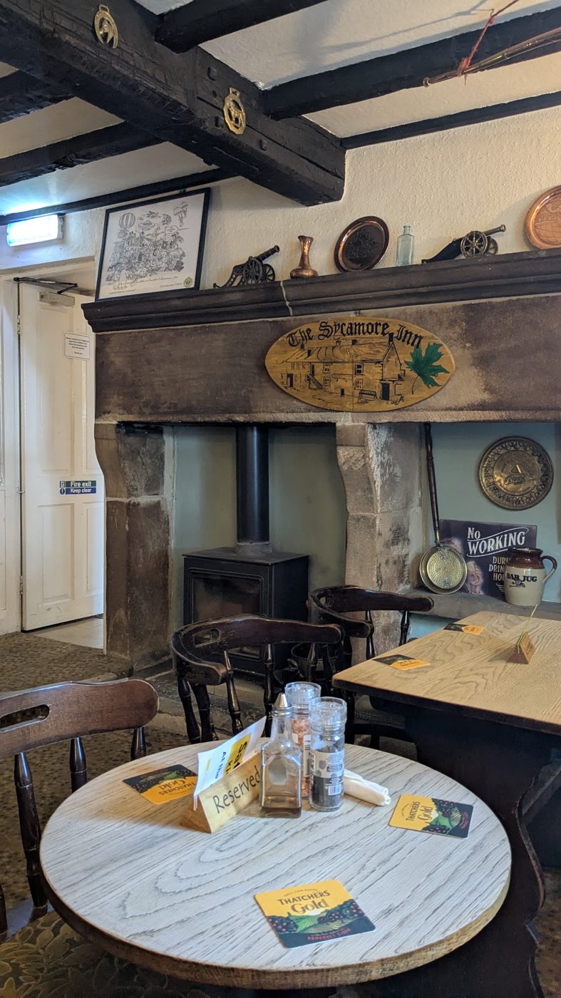 A table by the old inglenook fireplace